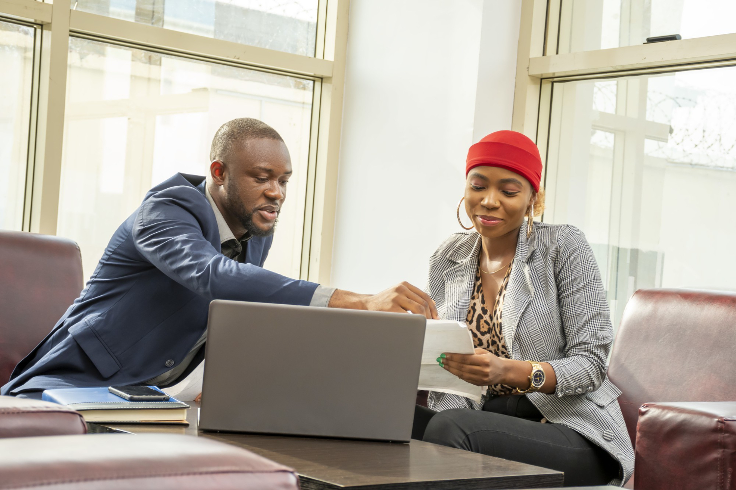 young-black-businessman-woman-going-through-some-paperwork-together